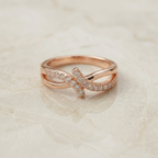 Rose gold ring with diamond accents on a light beige background