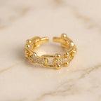 Gold ear cuff on a marble surface